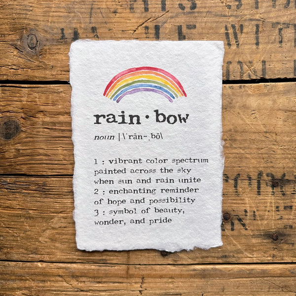 rainbow definition print on handmade cotton rag paper in typewriter font with a watercolor image of a rainbow by artist Patricia Shaw.