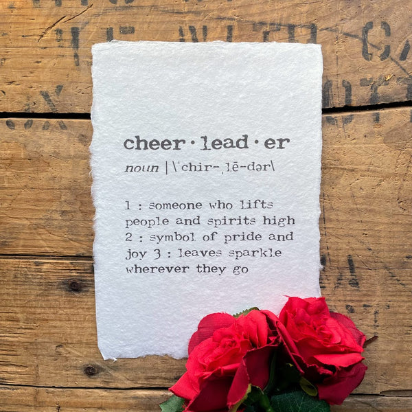 Cheerleader definition print in typewriter font on handmade cotton rag paper.