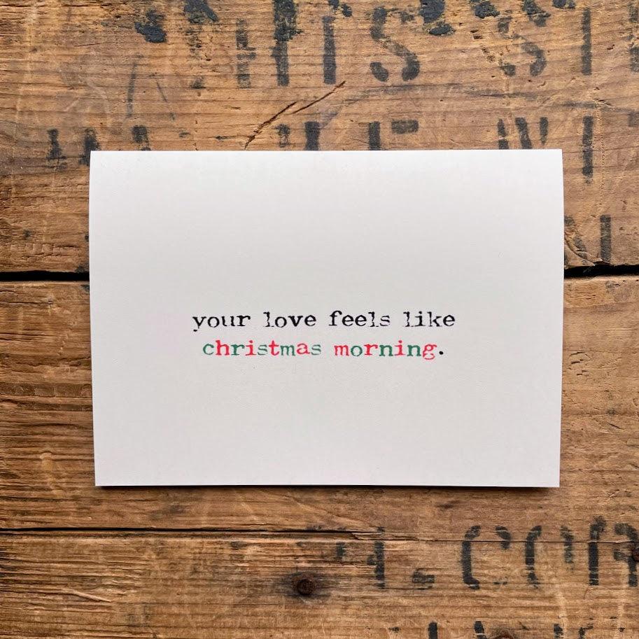 your love feels like christmas morning compliment greeting card with envelope and rose sticker seal.