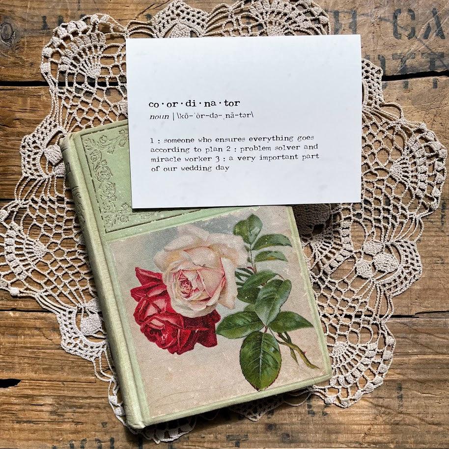 coordinator definition greeting card in typewriter font with an envelope and red rose sticker seal.