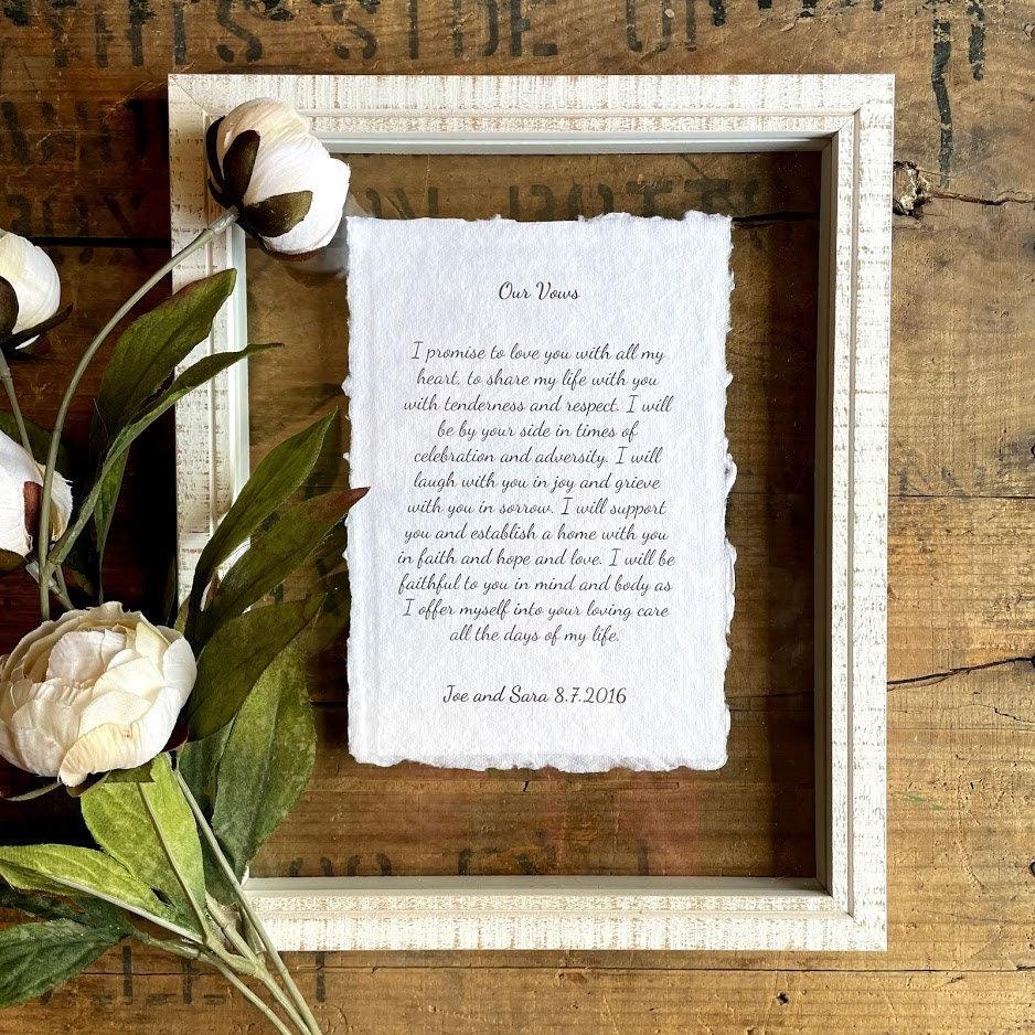 Wedding vows printed on handmade paper and displayed in a white floating frame