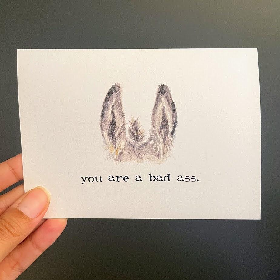 you are a bad ass compliment greeting card in typewriter font with envelope, donkey ears and tail illustration - Alison Rose Vintage