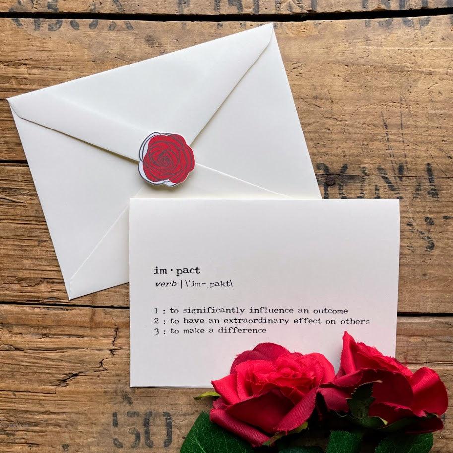 impact definition greeting card in typewriter font with envelope and rose sticker.  To impact is to significantly influence an outcome, to have an extraordinary effect on others, and to make a difference.