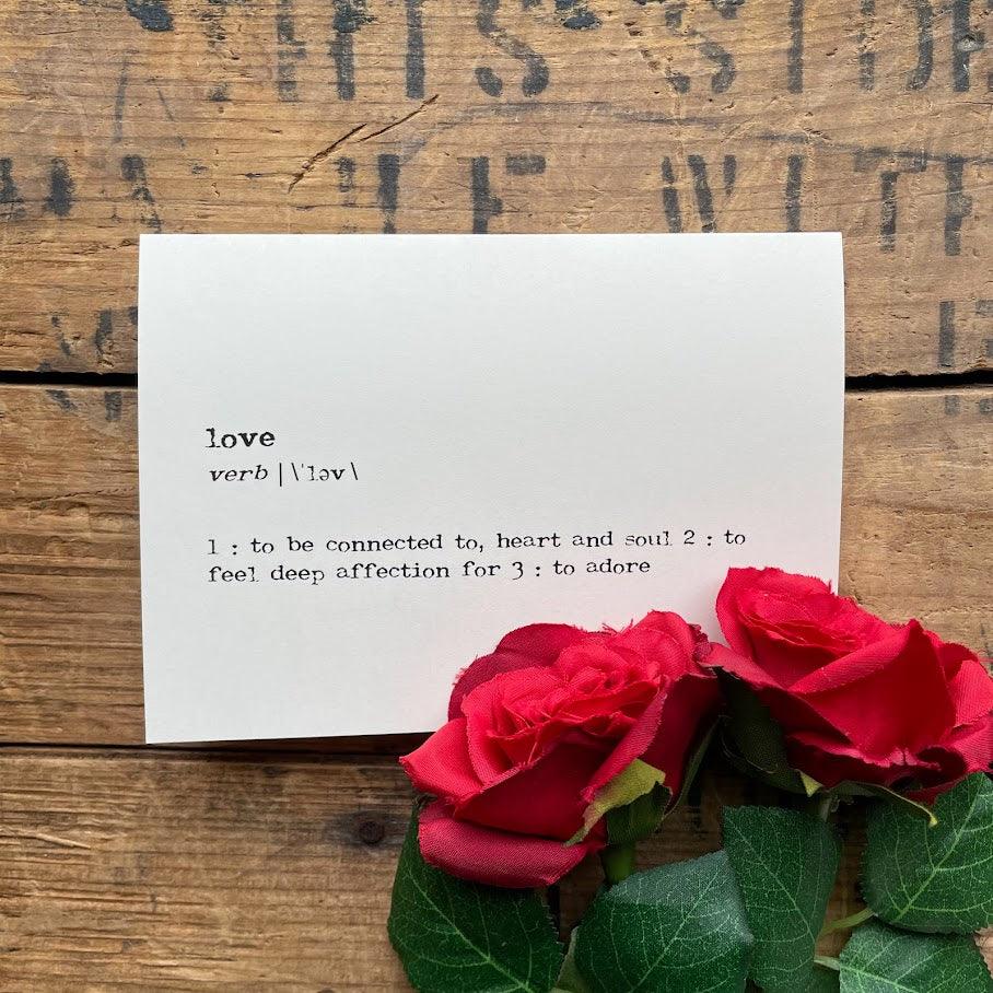love definition greeting card in typewriter font with envelope and rose sticker. 
